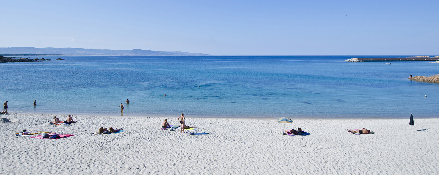 beach at Isola Rossa, white powder sand and clear blue water