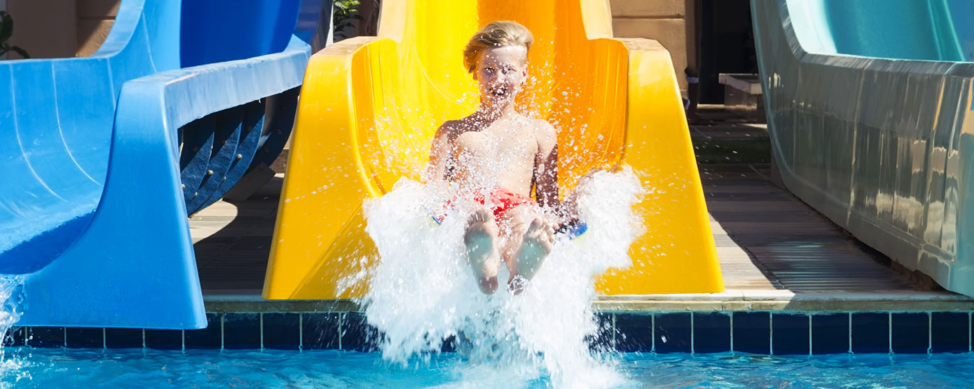 a kid enjoys the water toboggan in Acquafantasy water park Isola Rossa