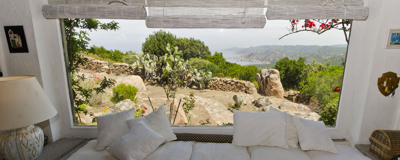 view through a big window in the living room of a villa Isola Rossa